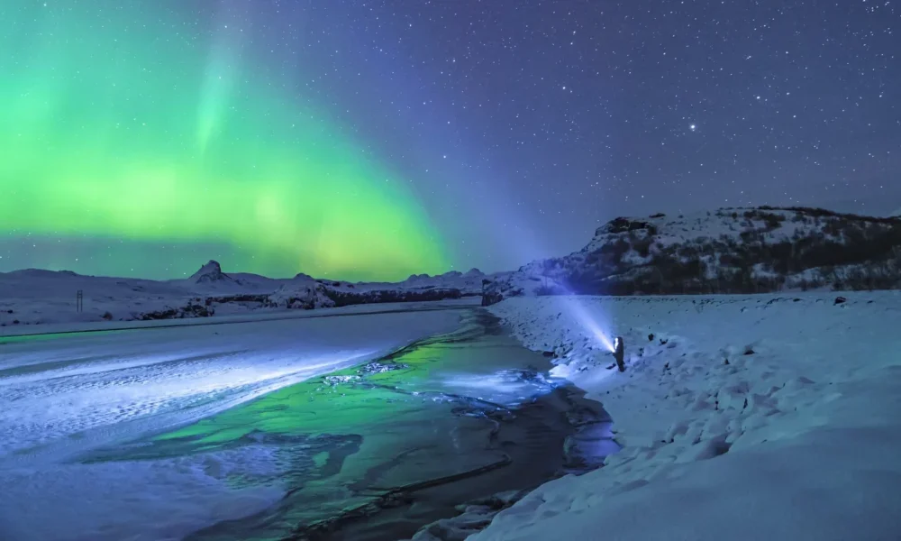 northern_lights_iceland_person_with_torch_jonatan_pie_unsplash_a3402caa84-scaled-r2k2l68qiqefwhjysssopaz9szotomrk6ywcvgmrn4